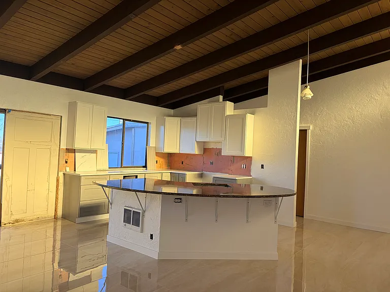 New kitchen cabinets and large granite Island with eating bar