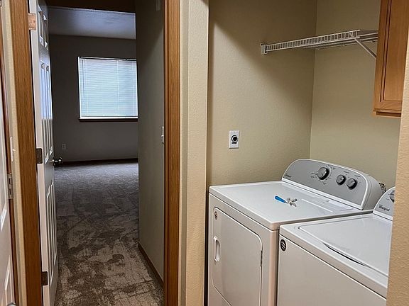 Washer and Dryer in entry way on 1st floor. Door leads to primary bedroom.