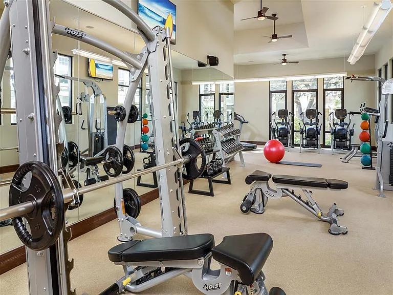 24hr Fitness Center with cardio machines, weight machines and free weights