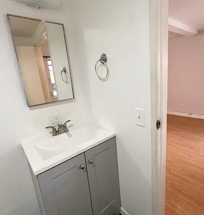 Spacious bathroom with newer vanity and toilet and large shower