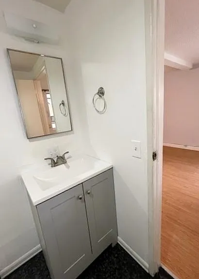 Spacious bathroom with newer vanity and toilet and large shower