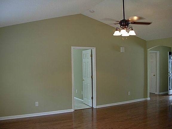 View of great room with new hardwood floors, cathedral ceilings, & new paint!
