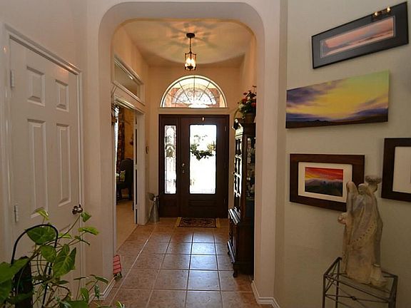 Entry offering a beveled glass front door onto a tile floor entry.