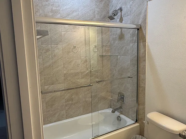 Upstairs shared bathroom with bathtub