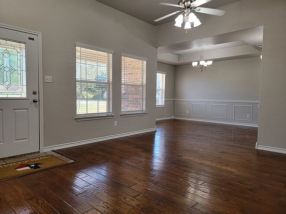 Entrance and dining room with dark hardwood floors