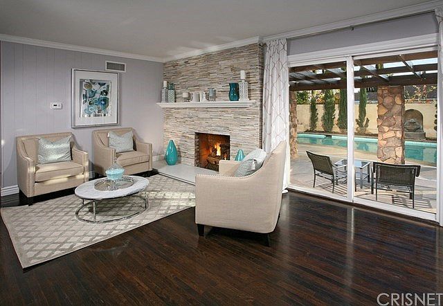 The spacious living room is bathed in natural ligh