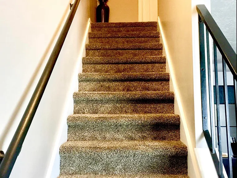 Stairway leading to bedrooms and bathroom.