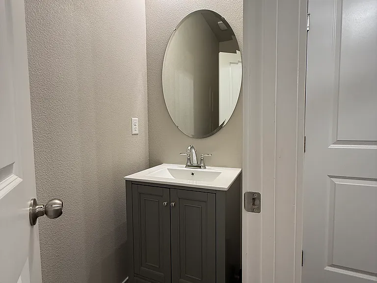 Half bathroom with updated vanity and lighting.