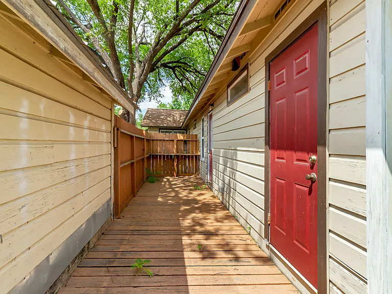back porch. Door in forefront to storage