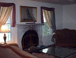 Living Rm, 25x13 with Hardwood Floors and Woodburning Fireplace and Marble Mantle