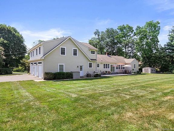 Exterior picture of the back of 609 Racebrook. Please note that the garage has 3 garage bays.