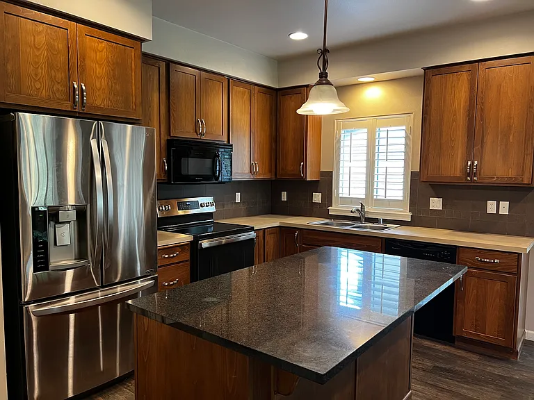 Kitchen has 42" cabinetry, updated Stainless fridge and stove with air fryer and large granite island.