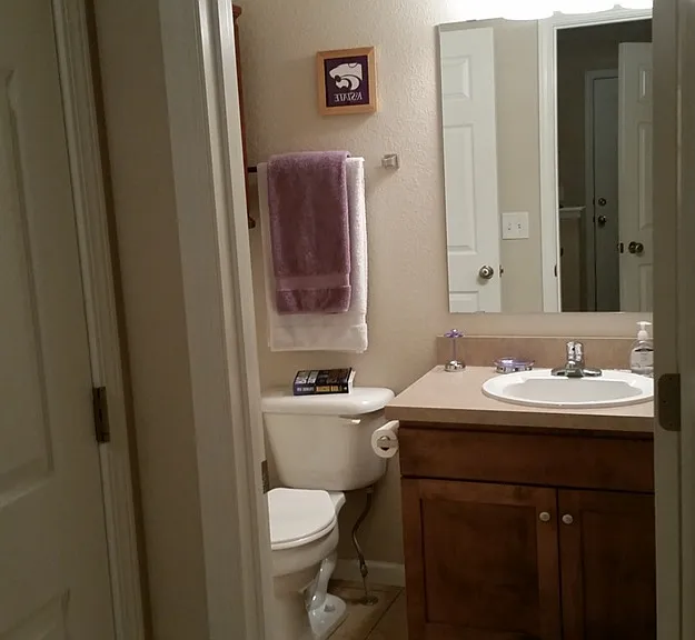 Guest Half Bathroom with door separating/connecting w/ the Primary Bathroom