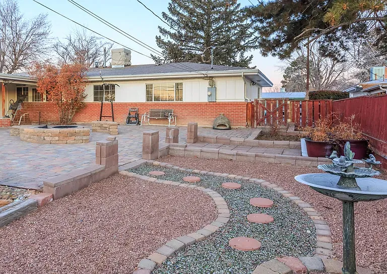 Huge backyard, landscaped for relaxation and entertaining. Enjoy evenings around the built-in fire pit, gather with friends in the multiple seating areas, or grow your favorite flowers and vegetables in the two dedicated gardening spaces.