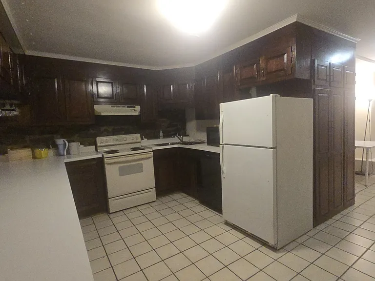 The Kitchen. The white object on the left is the countertop. The kitchen has an unusually large number of cupboards.