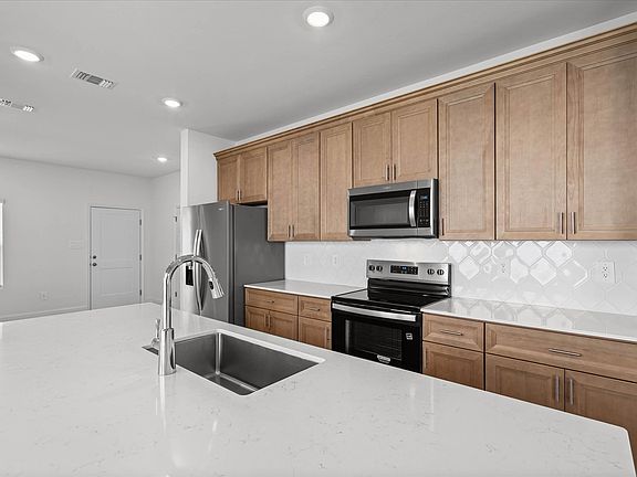 Kitchen in the Westbrook floorplan at a Meritage Homes community in Ocean Springs, MS.