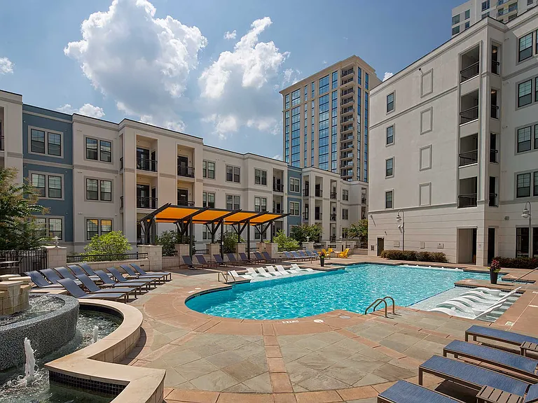 Pool with in-water and dry lounge seats, fountain and covered seating