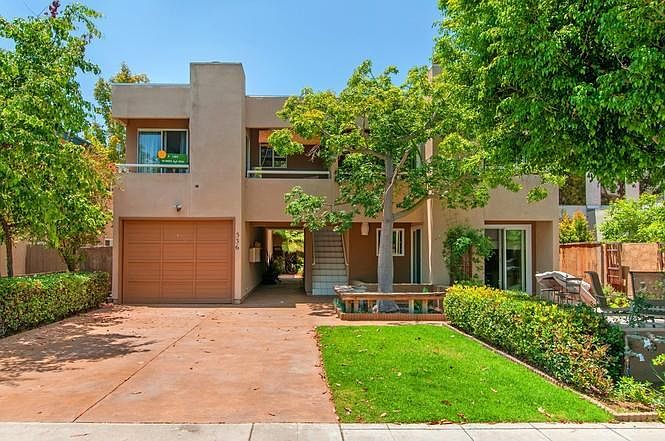View from the street. The unit is upstairs left with two balconies facing out. Off-street garage and parking in the back, accessible from the alley.