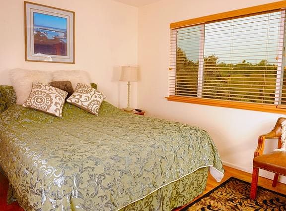 Master bedroom w/queen bed, large picture window with greenb