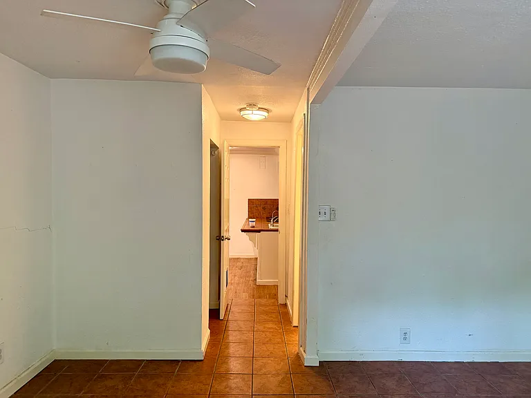Standing directly in front of 3rd bedroom hallway (windows behind) with kitchen counter visible ahead, so you can get a sense for layout. A door at the end of this hallway closes off the whole 3rd BR area for privacy.