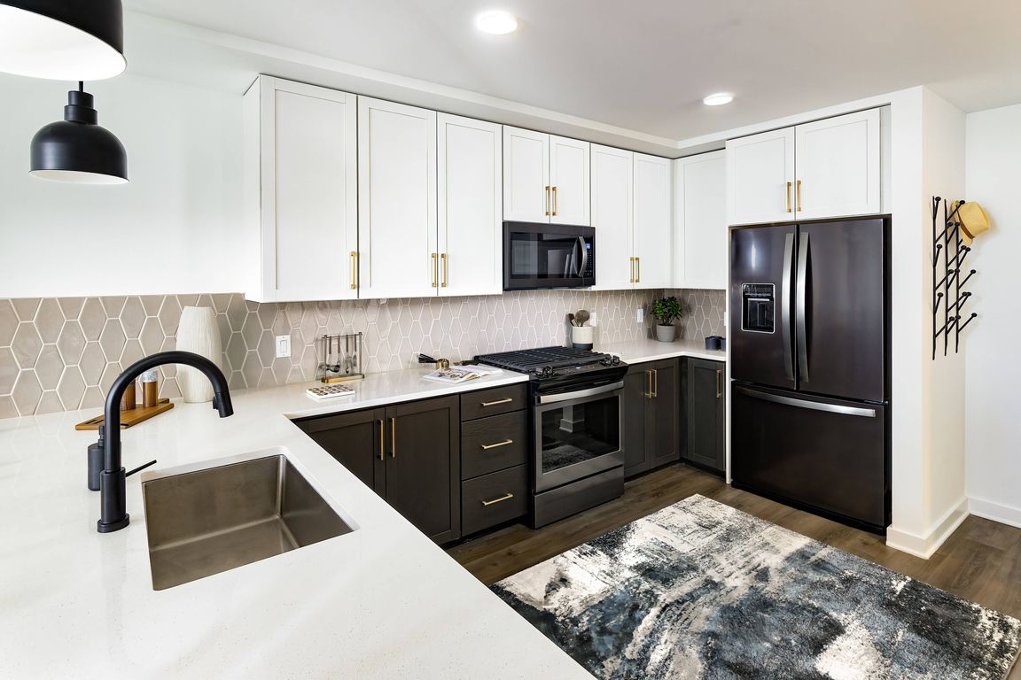 Kitchen with Gas Range Stovetops and Stainless Steel Appliances