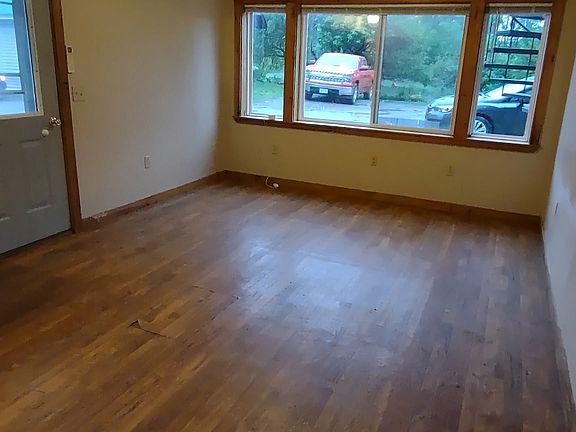 View towards front door and living room from dining area