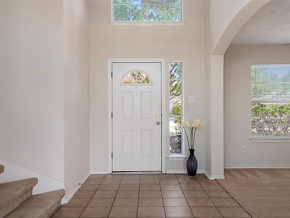 Upon entering, you will see ceramic tile flooring, soaring ceilings and a nice archway that leads to the formal dining or home office space.