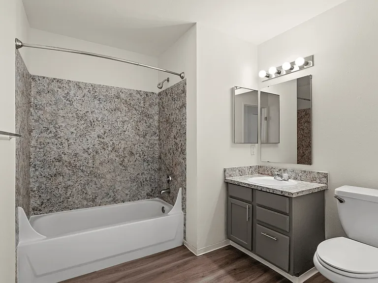 Updated bathroom with a full-size tub, vanity storage, and modern finishes. Updated bathroom with a full-size tub, vanity storage, and modern finishes.
