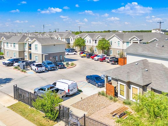 Overhead view of La Joya Apartments in Laredo, Texas, featuring a residential area with parked cars in driveways