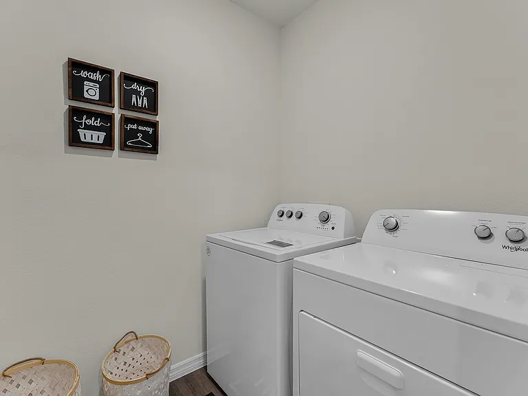 Spacious laundry room with full-size washer and dryer.