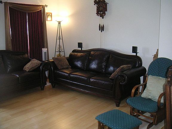 Living Room is detailed with wood flooring and a cozy fireplace