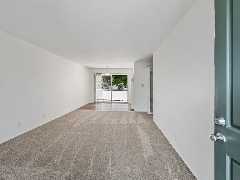 View from the front door of an upper 1BR unit. Upper units feature new carpeting and a balcony.
