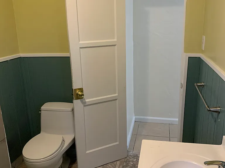 Full Bathroom at end of hallway, view from inside.