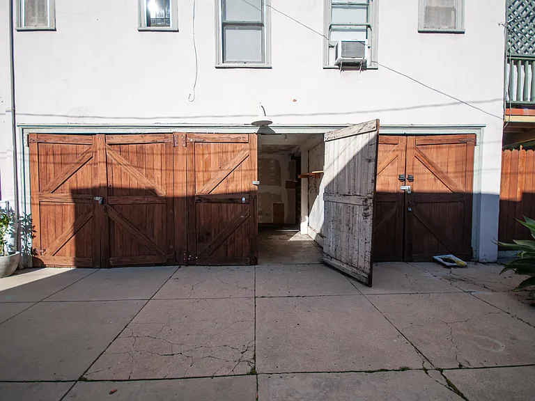 Garage fits 4-door sedan with extra storage but not bigger vehicles.
