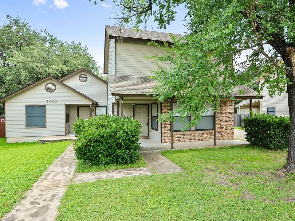 Front of property. Unit A is two-story to the right in photo. Beautiful shade tree in front of yard.
