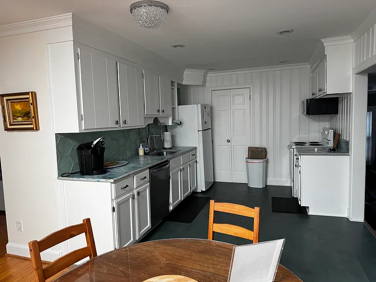 Kitchen opens to the dining table and then to the sunroom and backyard!