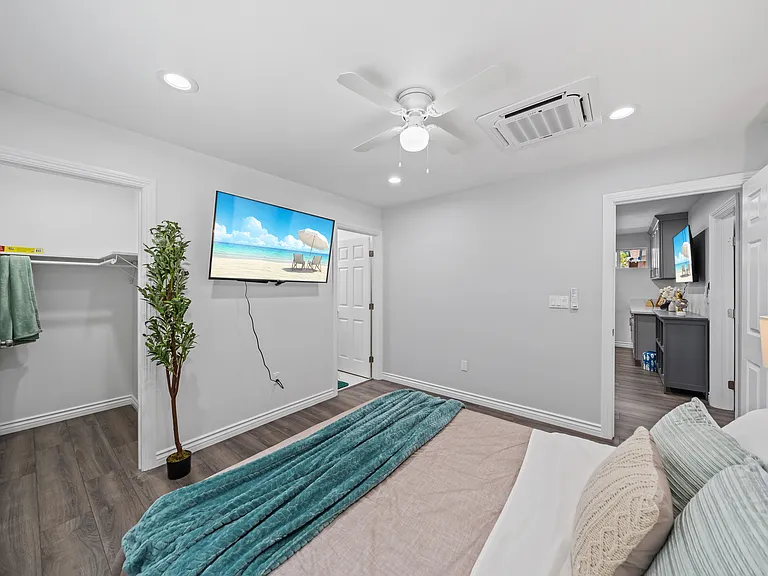 This clean, quiet bedroom offers a TV for entertainment and a closet to keep your items organized.
