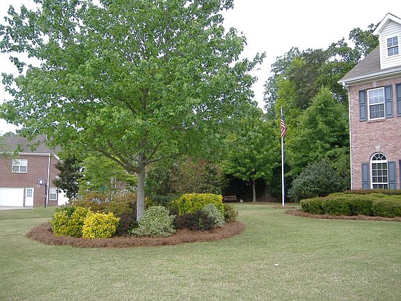 Large meticulously maintained yard with lots of mature plantings