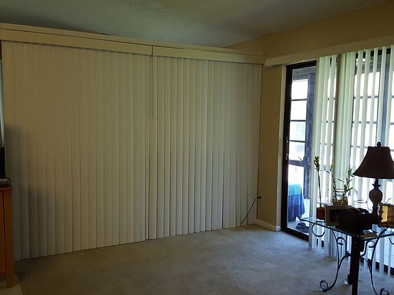 closed vertical blinds to separate bedroom from living room
