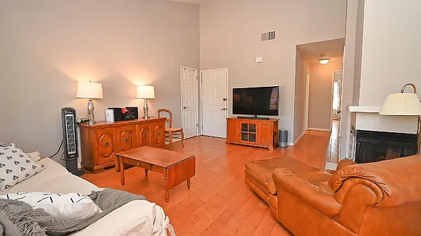 Main Living Area Facing Door Huge Window behind white couch