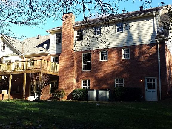 Rear of house
						:
						Brand new back porch overlooking acres of private wood lands. SmokeRiseHome.com