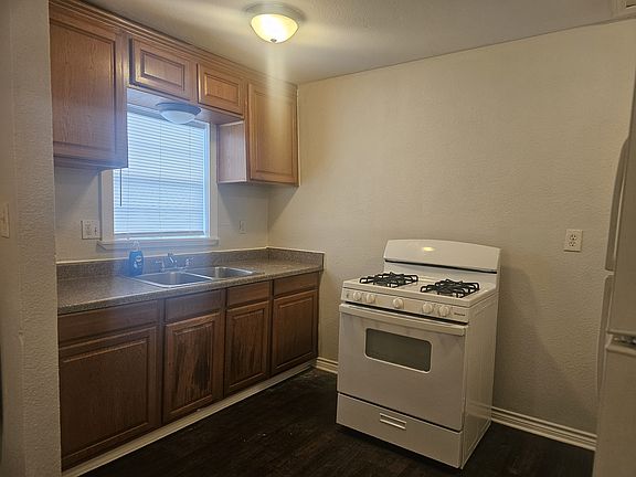 Kitchen has a gas stove and a refrigerator. You can move the refrigerator to a different spot. No garbage disposal or dishwasher.
