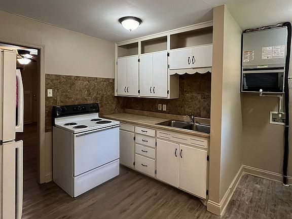 Kitchen adjacent to laundry room with new heat pump hvac