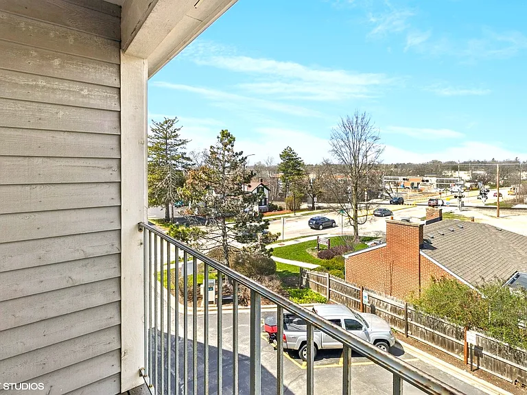 Balcony view across street from park district and restaurants.