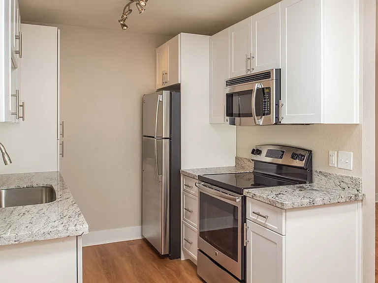 Modern kitchen with stainless steel appliances and granite countertops