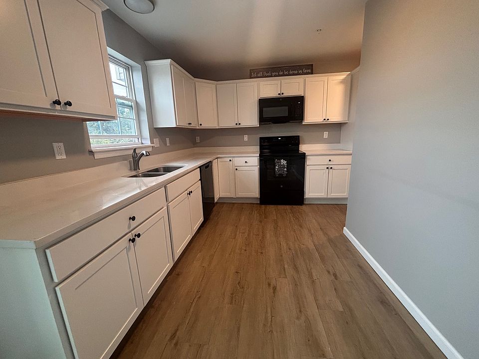 Upgraded kitchen, current photo. This has white cabinets, quartz counters, lvp flooring and 1 year old appliances.