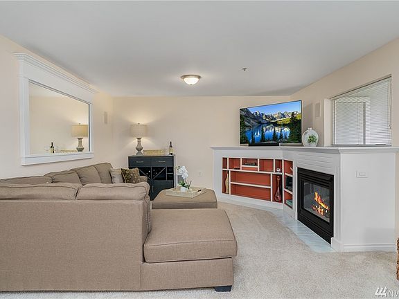 Living room features a natural gas fireplace surrounded by built-in shelving.
