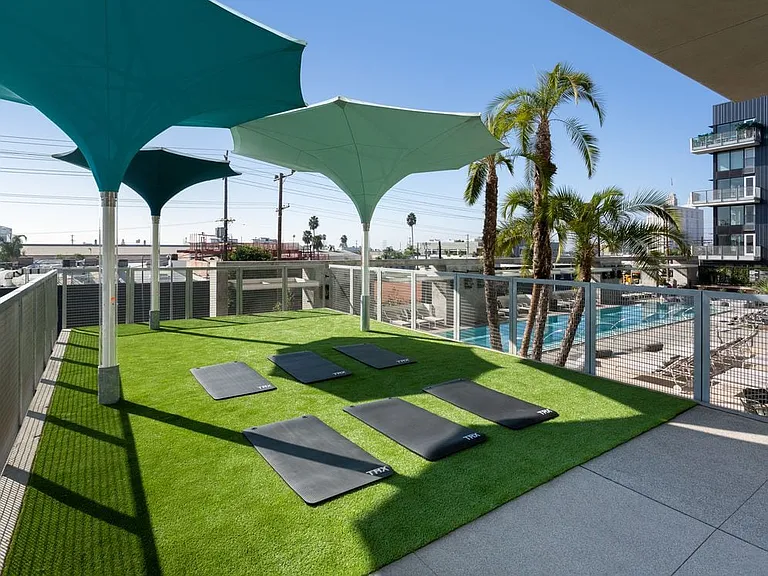 Outdoor yoga deck overlooking pool