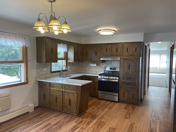 Walnut kitchen with granite countertops and stainl
