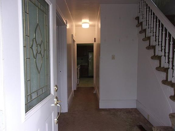 Sunlit entry leads to living and dining rooms on left, with kitchen straight ahead.